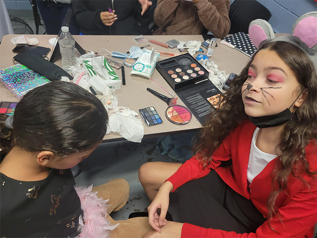 Girls in costume, face paint session.