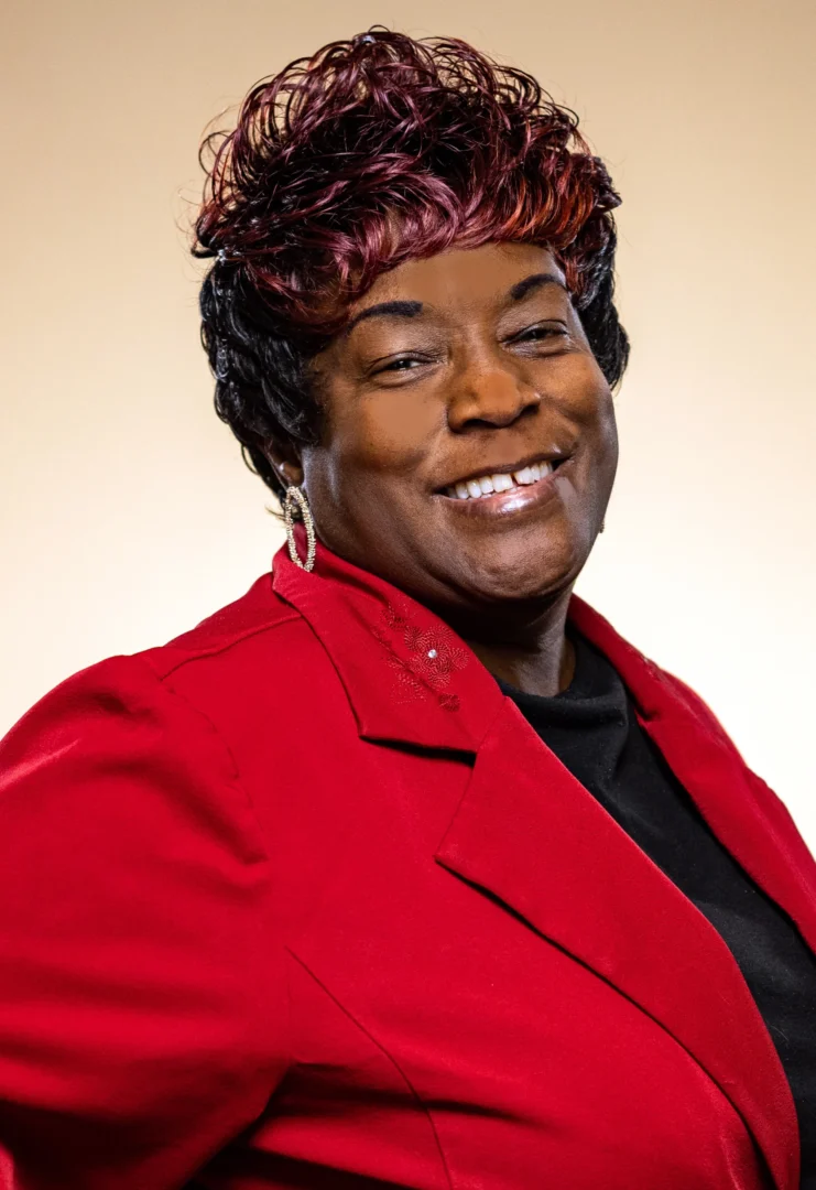 Smiling person in a red jacket.