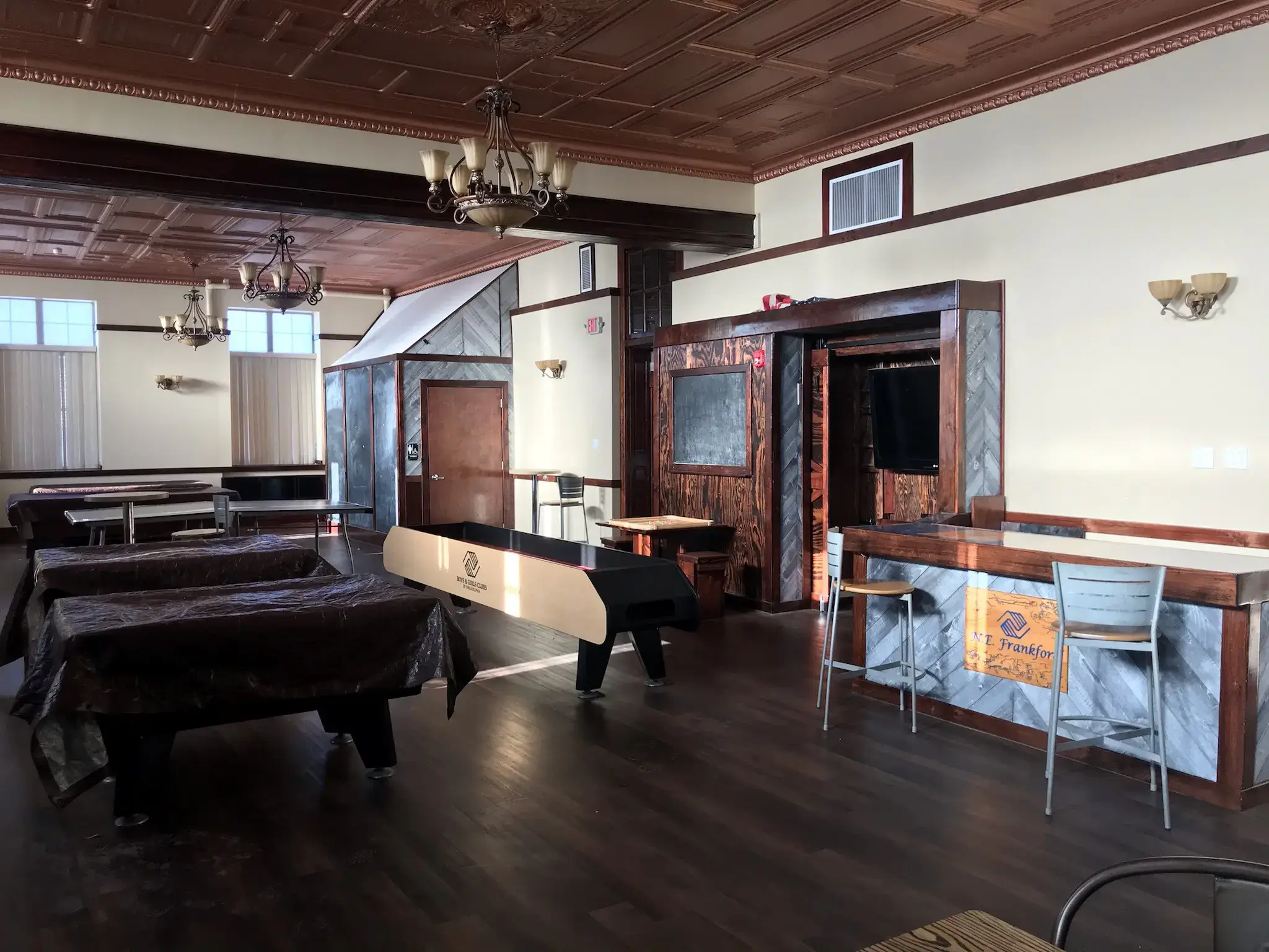 Empty room with pool tables and counter.